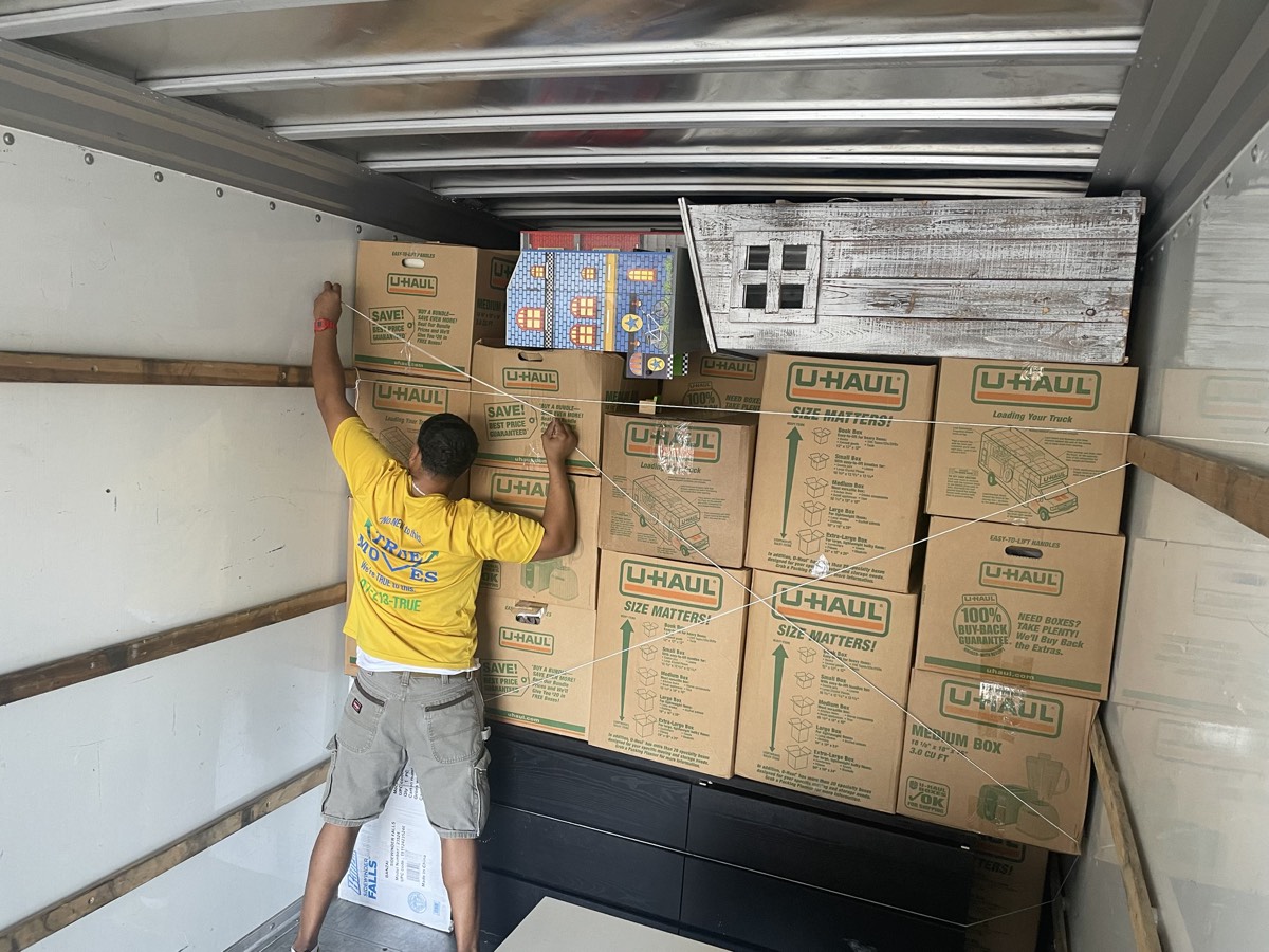 Mover stacking moving boxes neatly in the truck